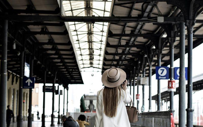 A student arriving with her luggage at the station